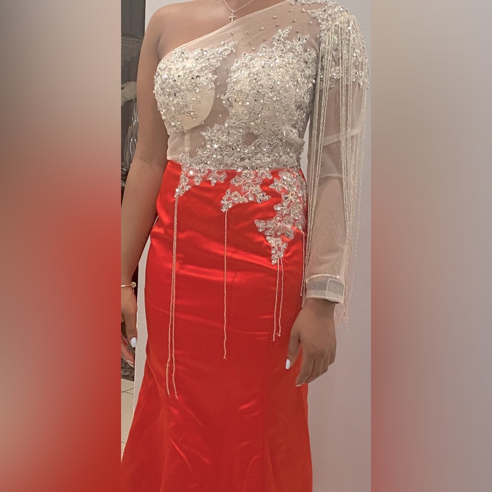 I am selling this beautiful red mermaid one shoulder crystal beaded prom dress.